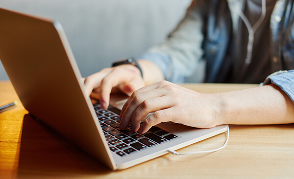 Woman typing on laptop